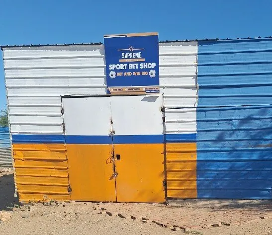 Supreme Sport Bet Shop building painted in blue and orange